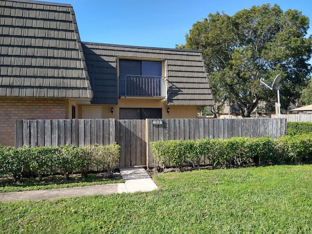 rear view of house with a lawn