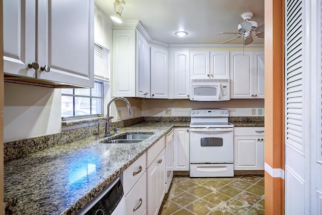 kitchen featuring dark stone countertops, white cabinetry, sink, and white appliances