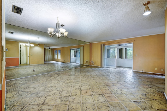 empty room featuring a chandelier