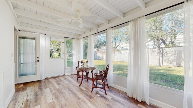 sunroom featuring ceiling fan, beam ceiling, and wooden ceiling