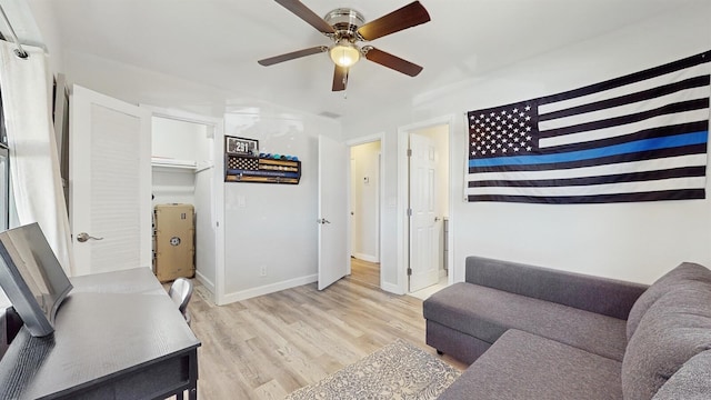 living room featuring ceiling fan and light hardwood / wood-style floors