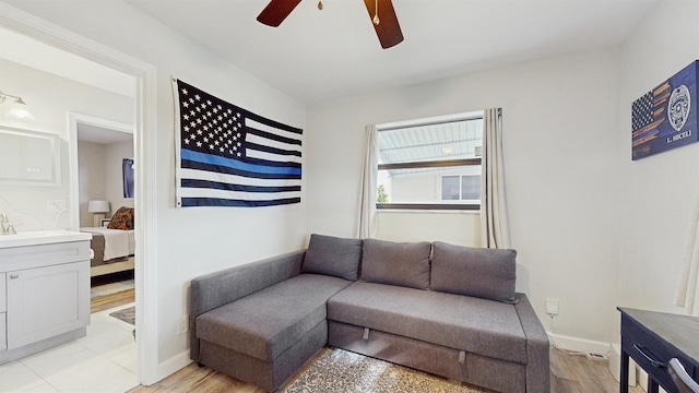 living room with ceiling fan and light hardwood / wood-style floors