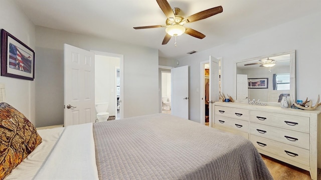 bedroom with hardwood / wood-style floors, ceiling fan, and ensuite bathroom