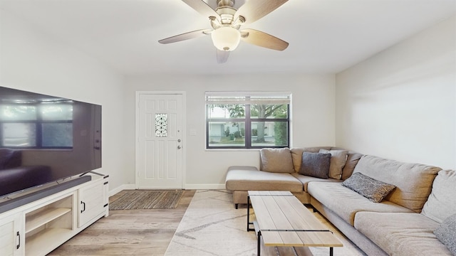 living room featuring light hardwood / wood-style flooring and ceiling fan