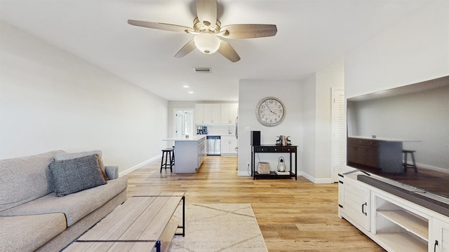 living room featuring ceiling fan and light wood-type flooring