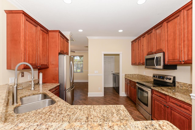 kitchen featuring appliances with stainless steel finishes, light stone counters, ornamental molding, and sink