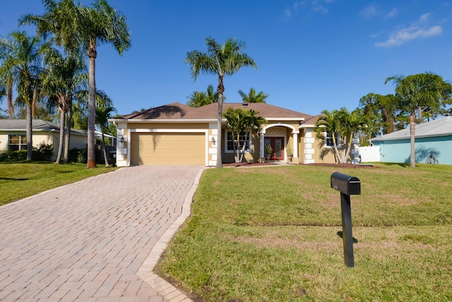 single story home with a garage and a front lawn