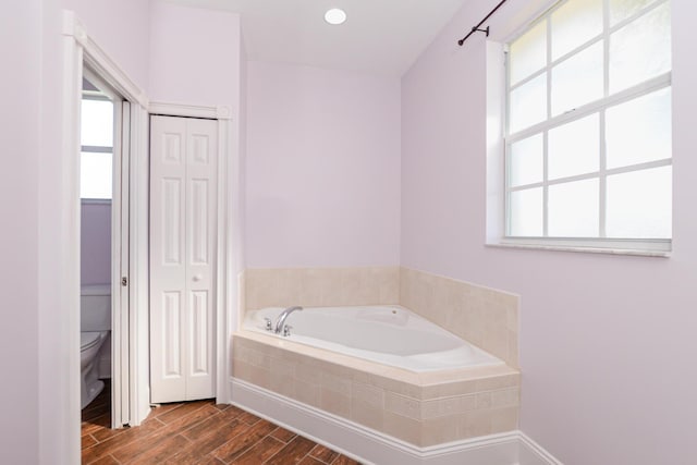 bathroom with tiled bath and toilet