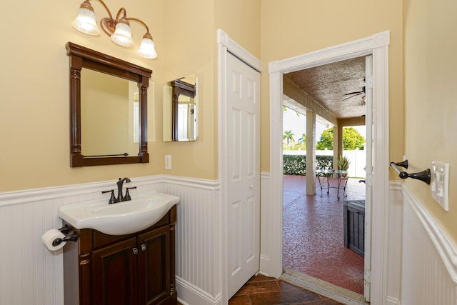 bathroom with ceiling fan and vanity