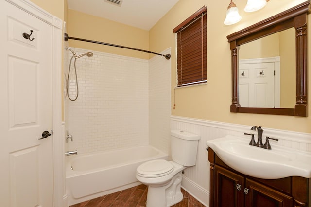 full bathroom featuring vanity, toilet, and tiled shower / bath