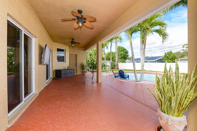 view of patio with ceiling fan and a fenced in pool