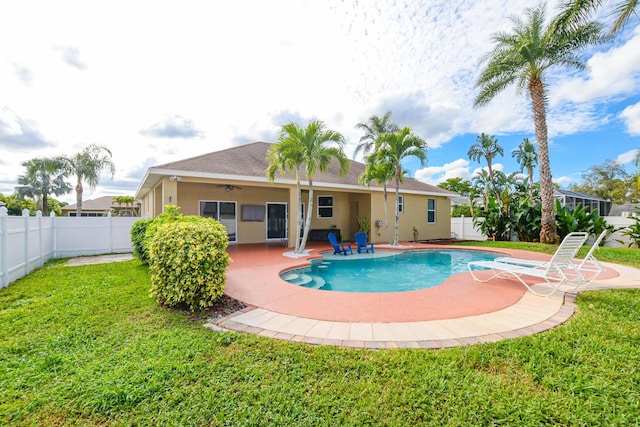 view of pool featuring a lawn and a patio