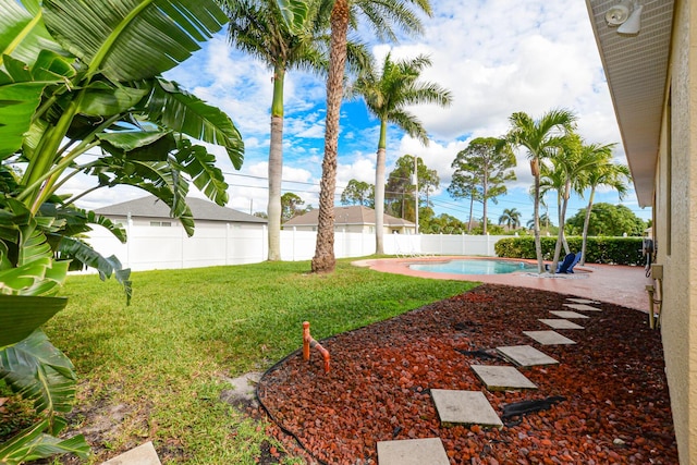 view of yard featuring a patio area and a fenced in pool