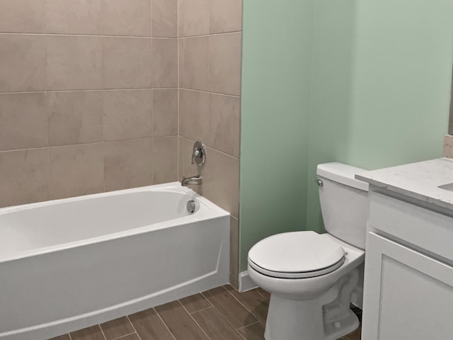 full bathroom with vanity, toilet, and tiled shower / bath combo