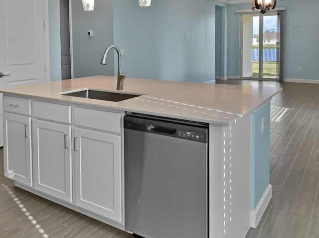 kitchen with white cabinets, sink, dishwasher, a chandelier, and an island with sink