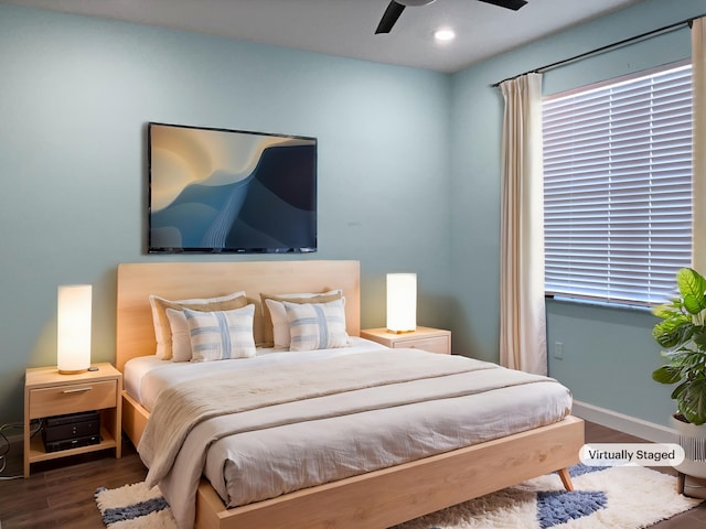 bedroom with ceiling fan and dark wood-type flooring