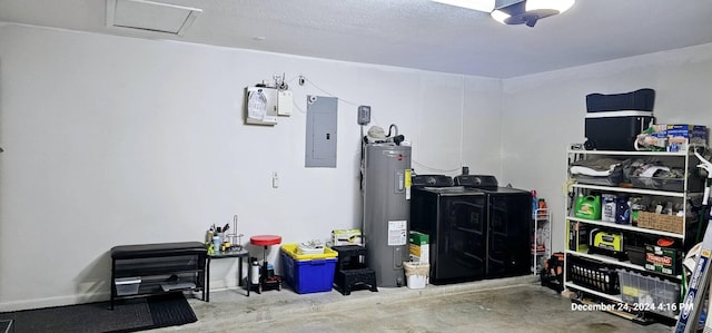 garage with washing machine and clothes dryer, electric panel, and water heater