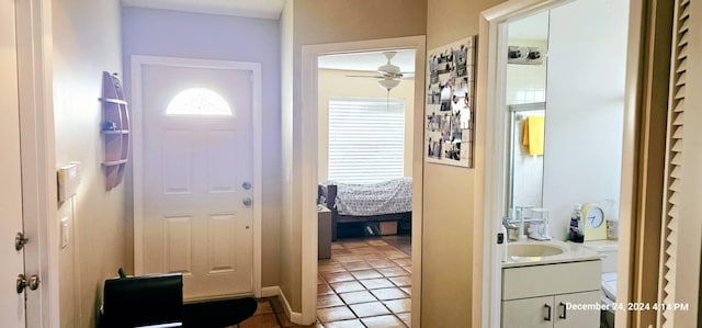 doorway featuring sink, ceiling fan, and light tile patterned flooring