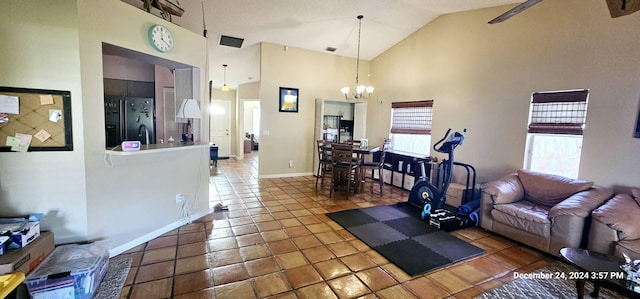 living room with tile patterned floors, ceiling fan with notable chandelier, and high vaulted ceiling