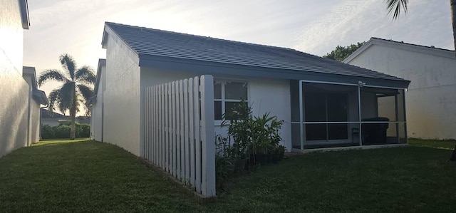 view of side of home with a lawn