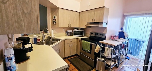 kitchen featuring ventilation hood, sink, dark tile patterned floors, light brown cabinetry, and stainless steel appliances