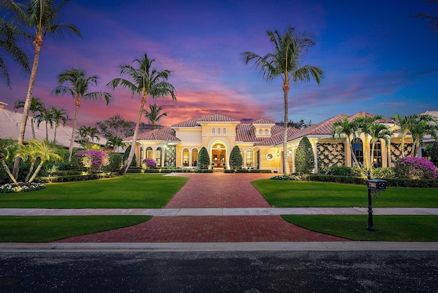 mediterranean / spanish house with a yard