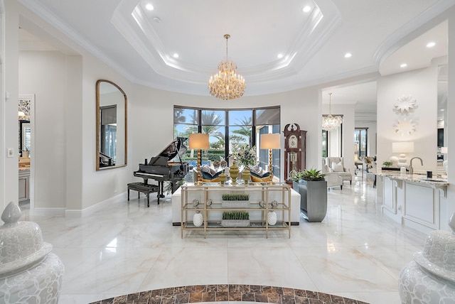 living room featuring a raised ceiling, an inviting chandelier, and ornamental molding