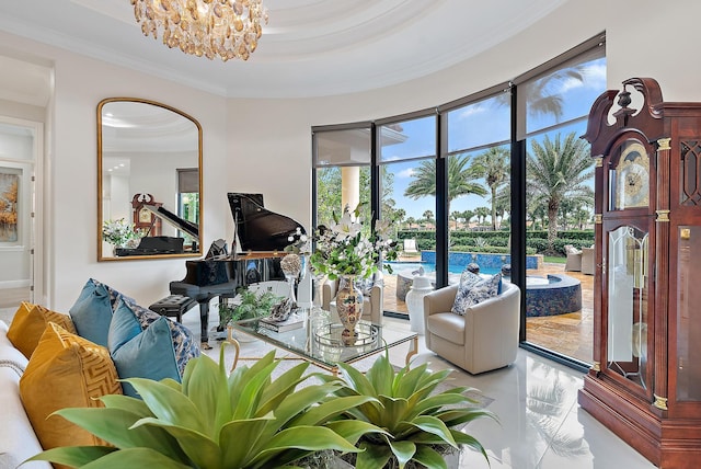 living room featuring a chandelier, a raised ceiling, and crown molding