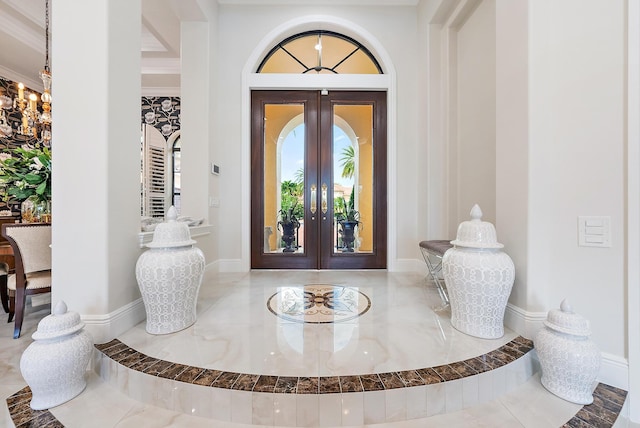 entrance foyer with french doors and crown molding