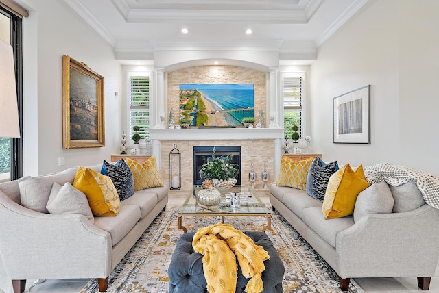 living room with a fireplace and crown molding