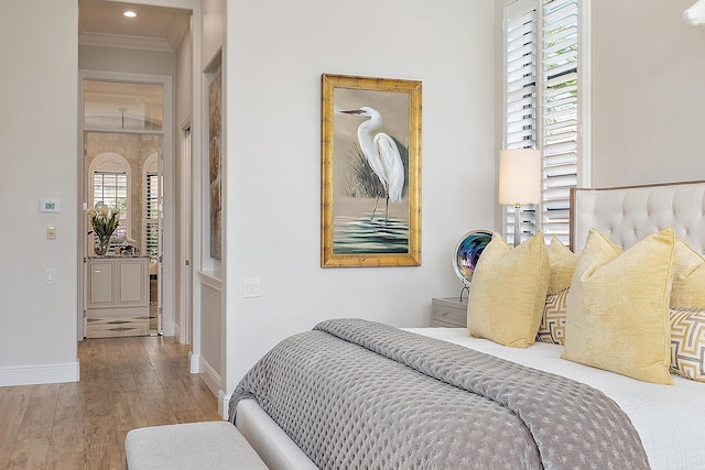 bedroom with hardwood / wood-style floors and crown molding