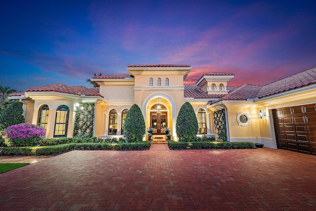 mediterranean / spanish house featuring french doors and a garage