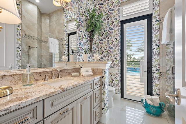 bathroom featuring vanity, toilet, and a shower with door