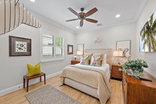 bedroom with ceiling fan, crown molding, and light hardwood / wood-style flooring