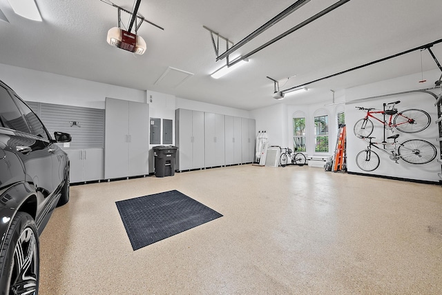 garage with electric panel and a garage door opener