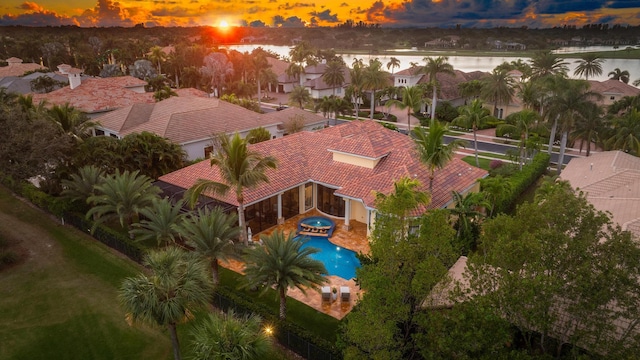 aerial view at dusk with a water view