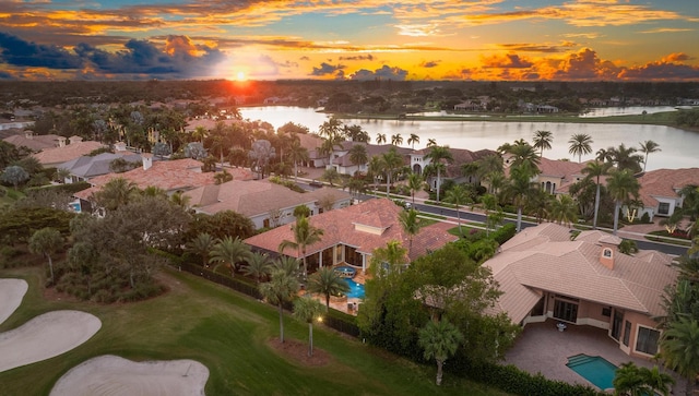 aerial view at dusk with a water view