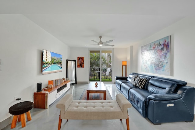 living room featuring concrete flooring and ceiling fan