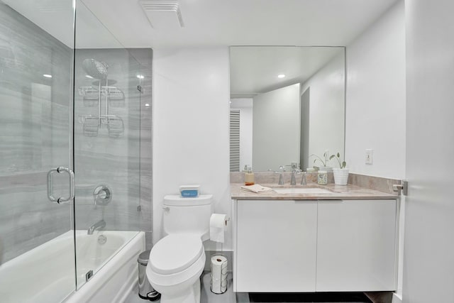 full bathroom with vanity, toilet, and combined bath / shower with glass door