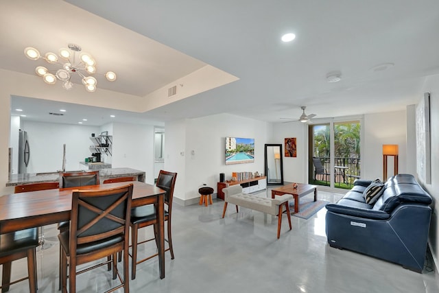 dining area with ceiling fan with notable chandelier