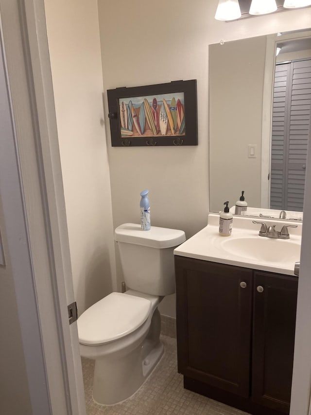 bathroom with tile patterned floors, vanity, and toilet