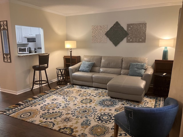 living room with dark hardwood / wood-style floors and crown molding