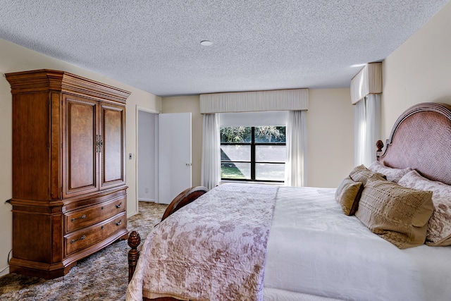 bedroom featuring light carpet and a textured ceiling