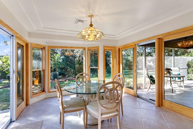 sunroom with a chandelier