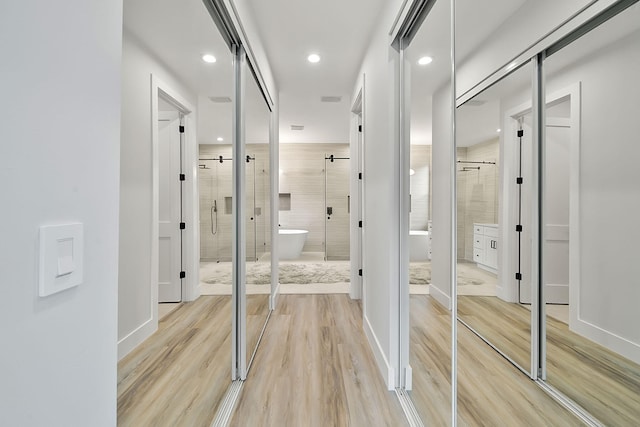 bathroom with plus walk in shower and wood-type flooring