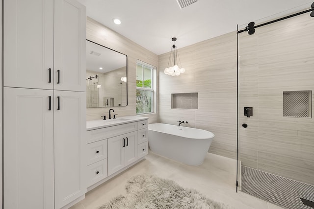 bathroom featuring tile patterned flooring, vanity, separate shower and tub, and tile walls