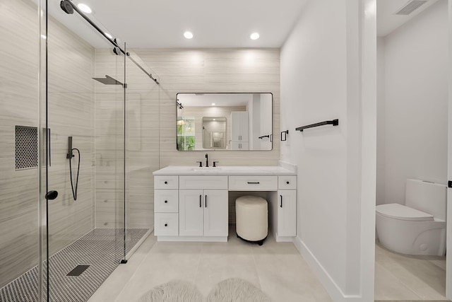 bathroom featuring tile patterned floors, vanity, an enclosed shower, and toilet