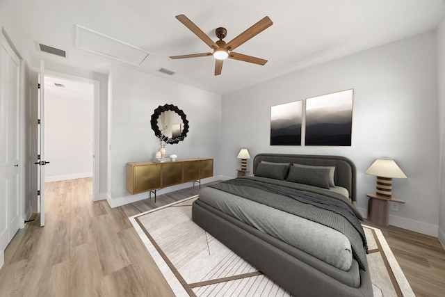 bedroom with light wood-type flooring and ceiling fan