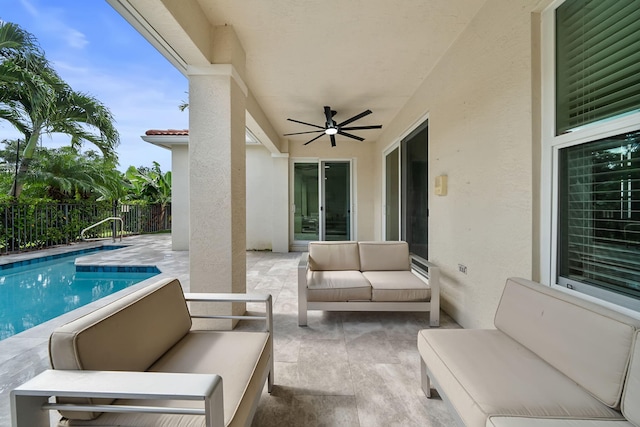 view of patio featuring outdoor lounge area, a fenced in pool, and ceiling fan