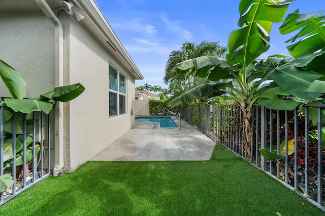 view of yard featuring a fenced in pool and a patio area